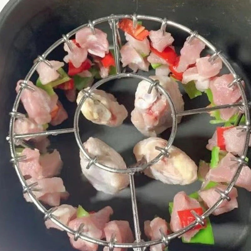 Ronde roestvrijstalen ovengrill met spies.